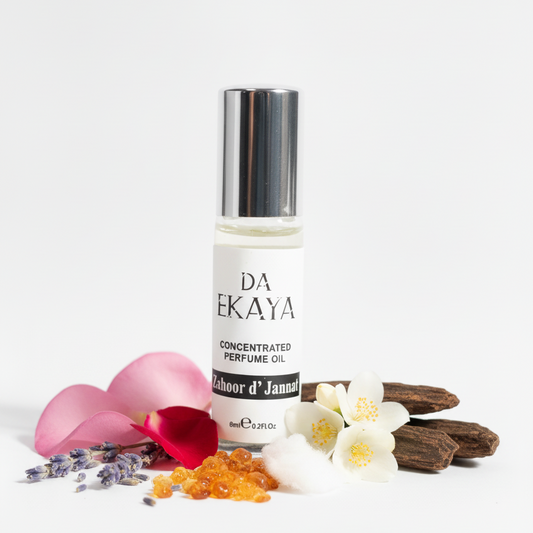 DA EKAYA concentrated perfume oil bottle with flowers and petals on a white background
